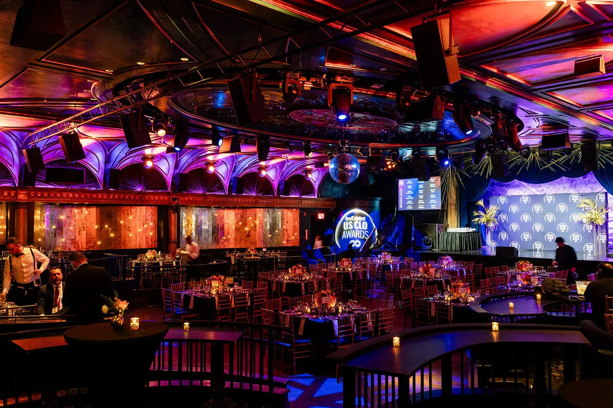Ballroom set for an industry awards gala, tables and stage lit before guests arrive