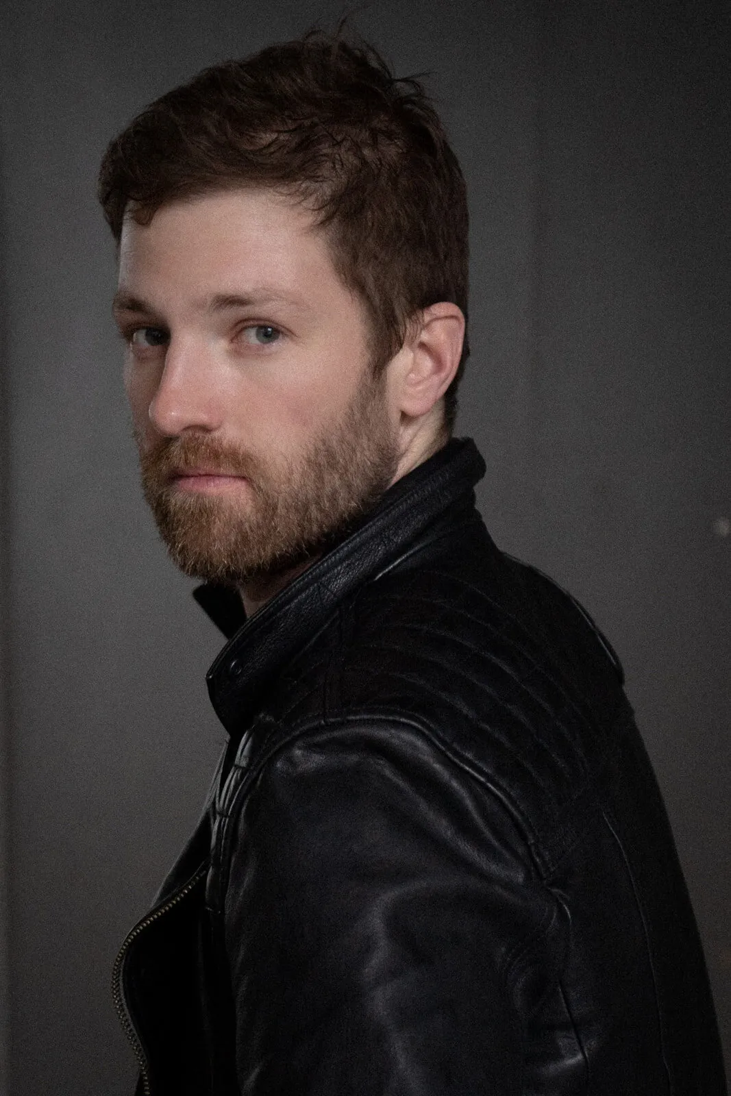 Executive portrait of a man against a plain grey studio background